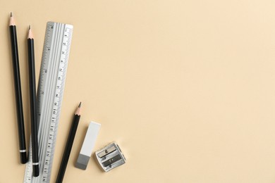 Photo of Flat lay composition with ruler and other stationery on beige background, space for text