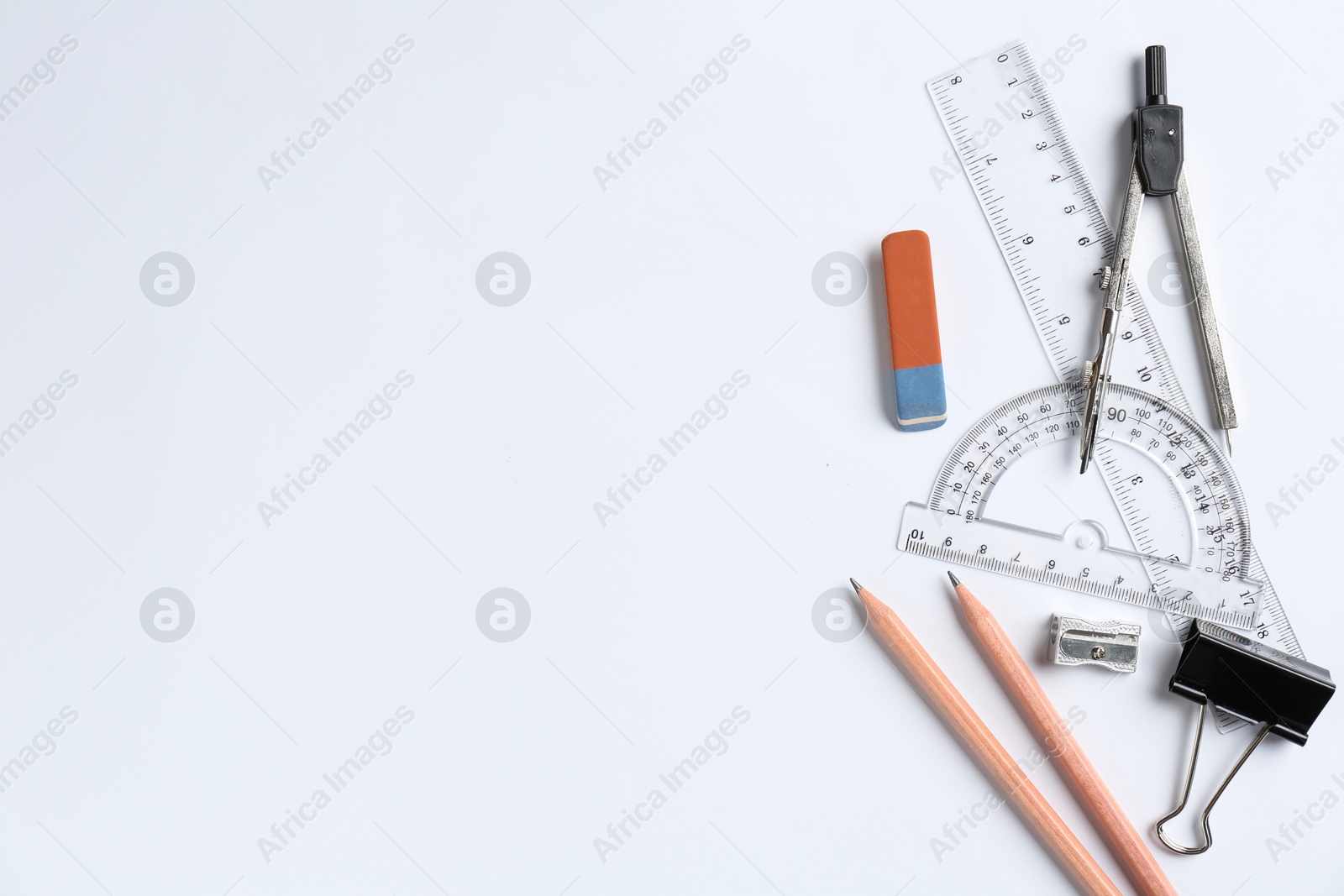 Photo of Flat lay composition with ruler and other stationery on white background, space for text