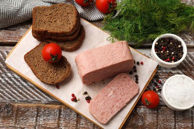 Photo of Canned meat, spices, tomatoes and bread on wooden table, flat lay