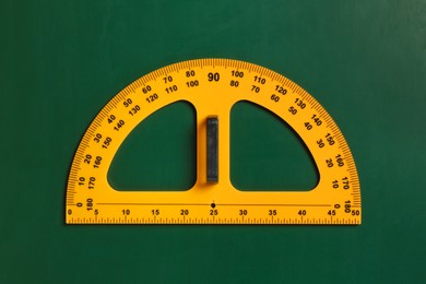 Photo of Protractor ruler on green chalkboard, top view