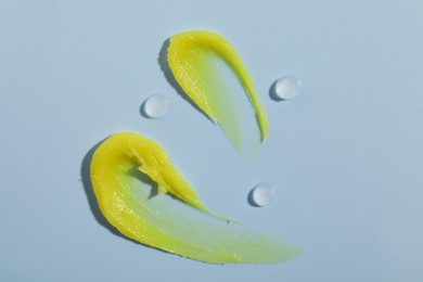 Photo of Different cosmetic products on light blue background, top view