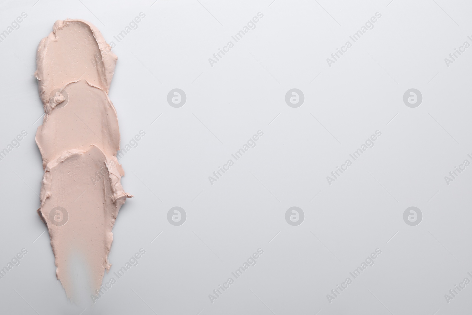 Photo of Cream isolated on white, top view. Sample of cosmetic product