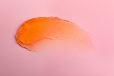 Photo of Sample of cosmetic product on pink background, top view