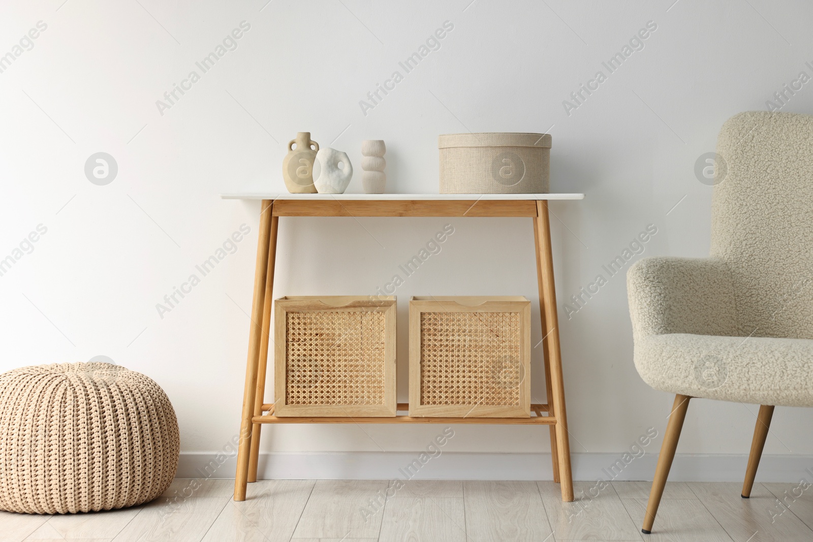 Photo of Stylish room interior with console table near white wall