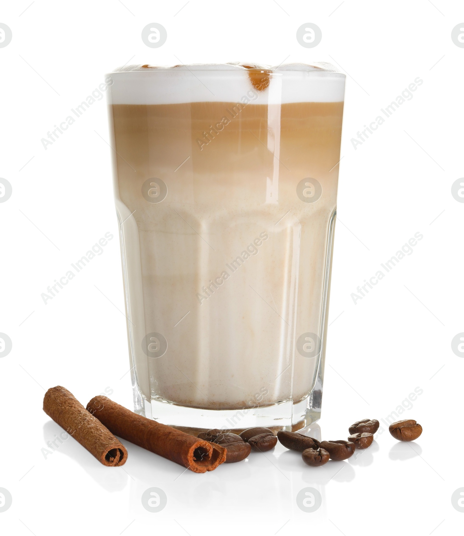 Photo of Tasty latte macchiato in glass, coffee beans and cinnamon isolated on white