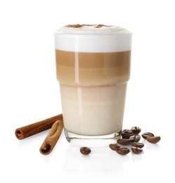 Photo of Tasty latte macchiato in glass, coffee beans and cinnamon isolated on white