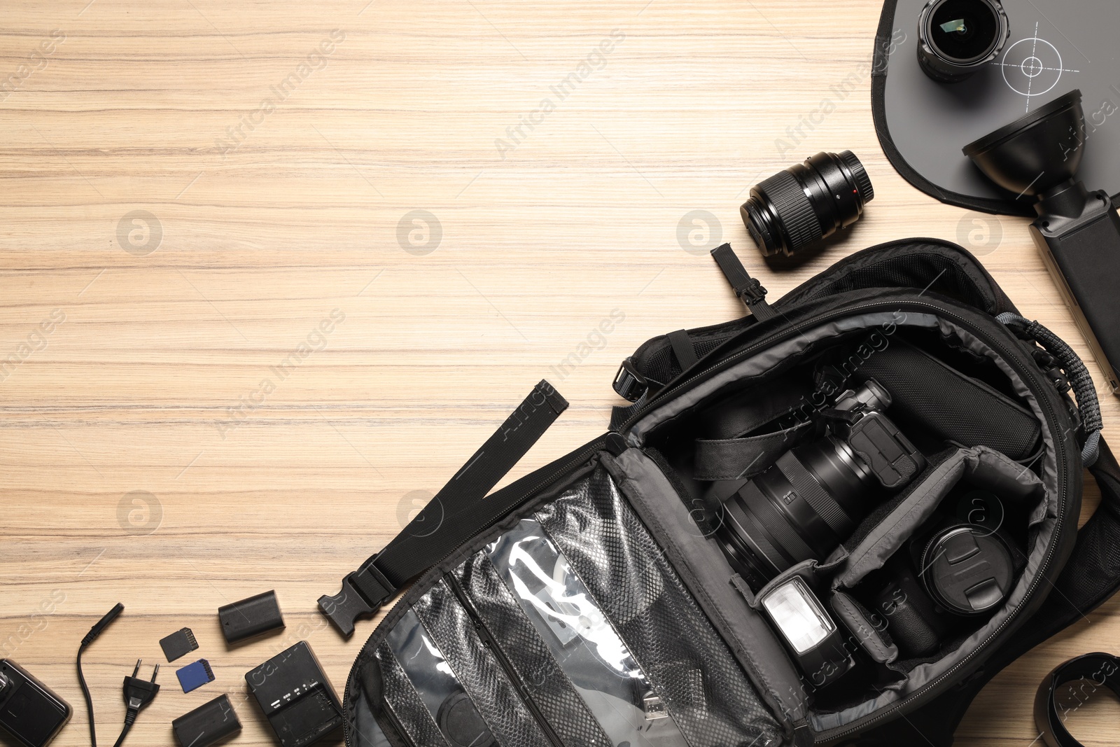 Photo of Photographer's equipment on wooden background, flat lay. Space for text