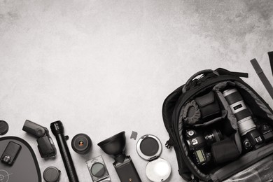 Photographer's equipment on grey background, flat lay. Space for text