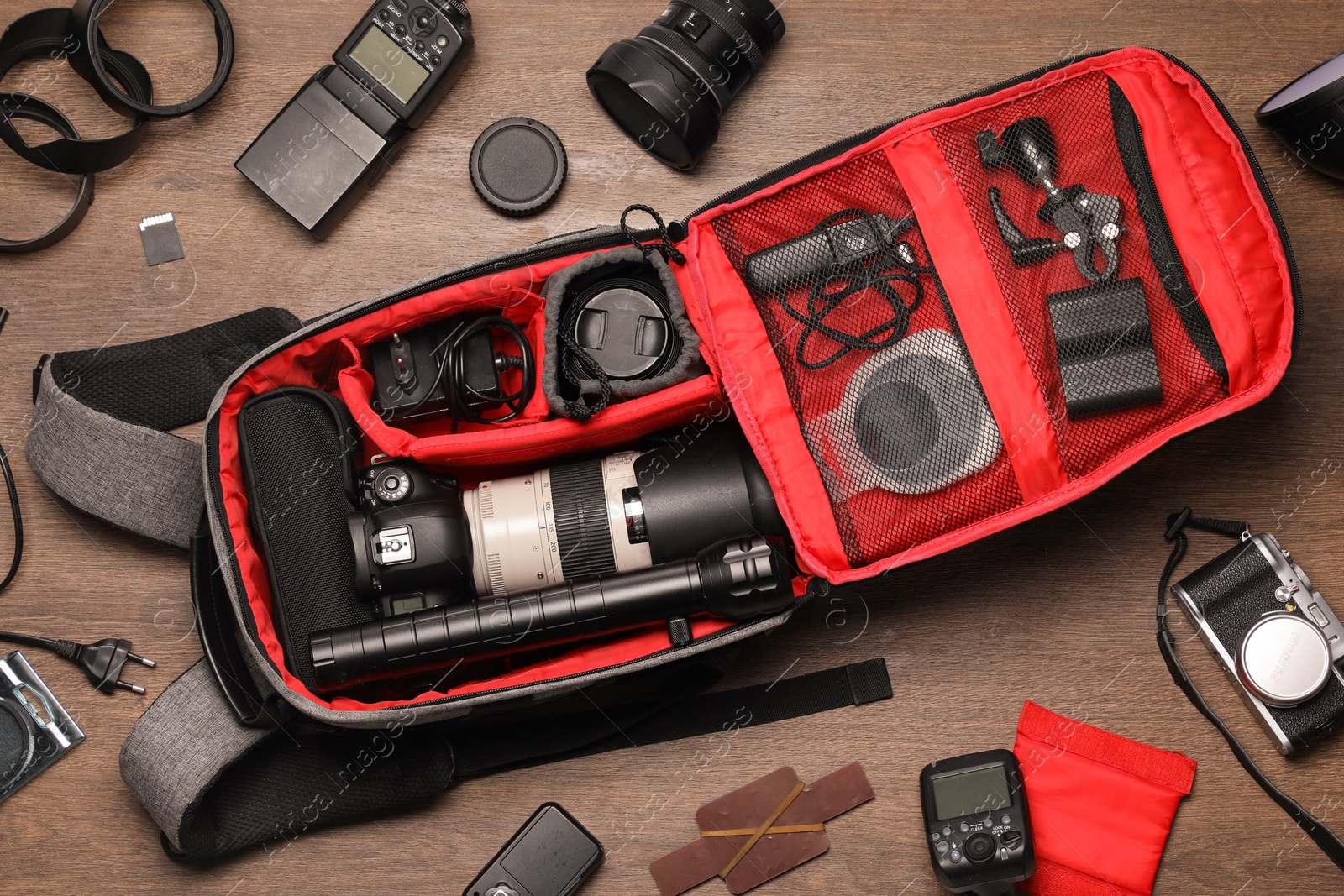 Photo of Photographer's equipment on wooden background, flat lay