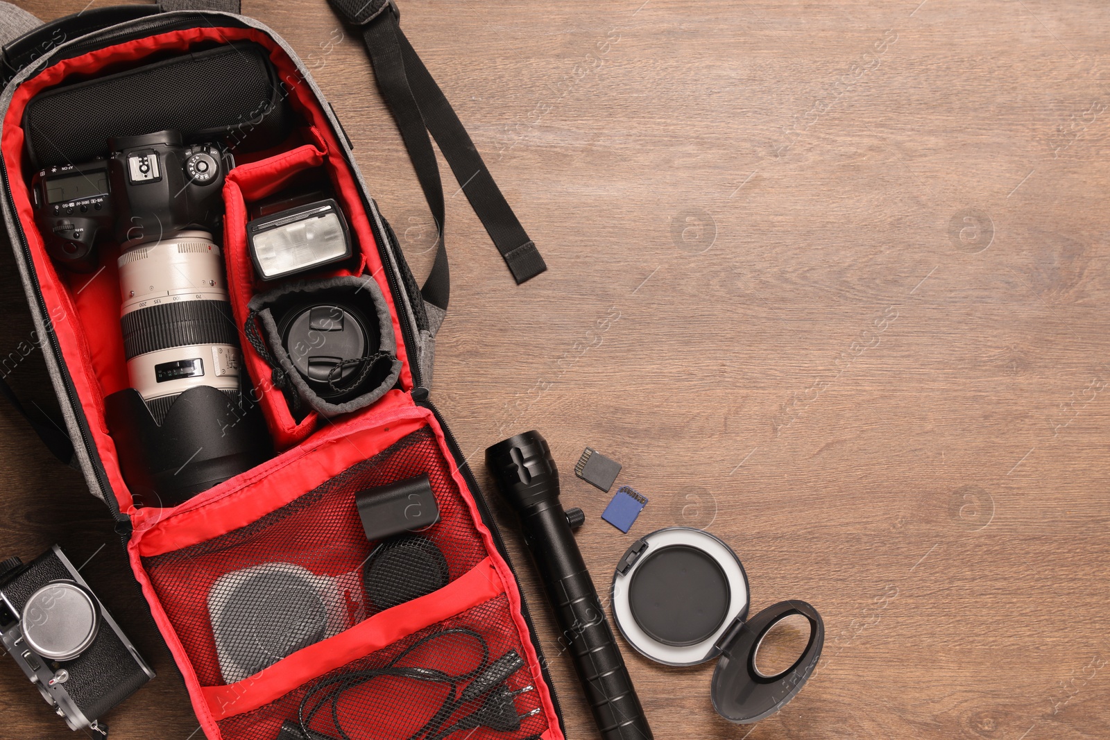 Photo of Photographer's equipment on wooden background, flat lay. Space for text