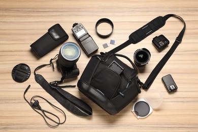 Photo of Photographer's equipment on wooden background, flat lay