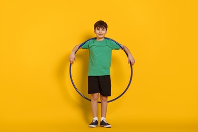 Photo of Boy with hula hoop on yellow background