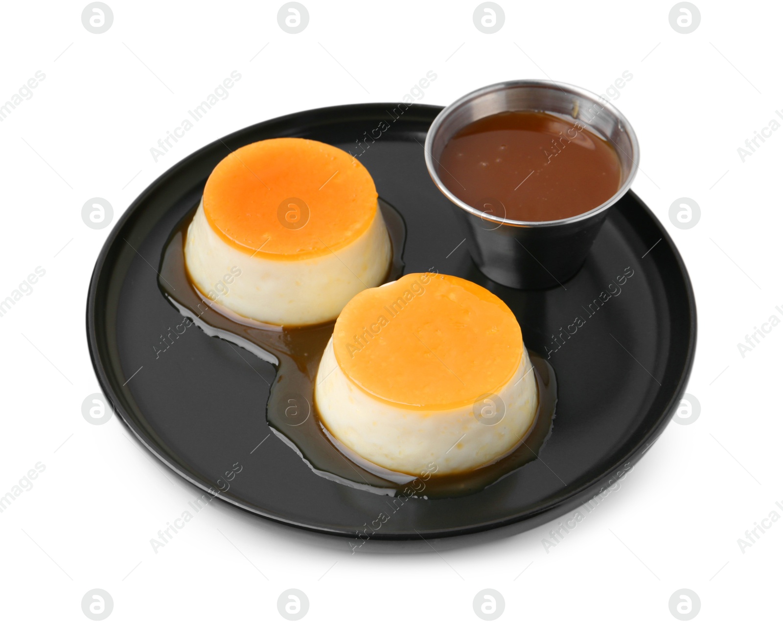 Photo of Tasty puddings with caramel sauce isolated on white