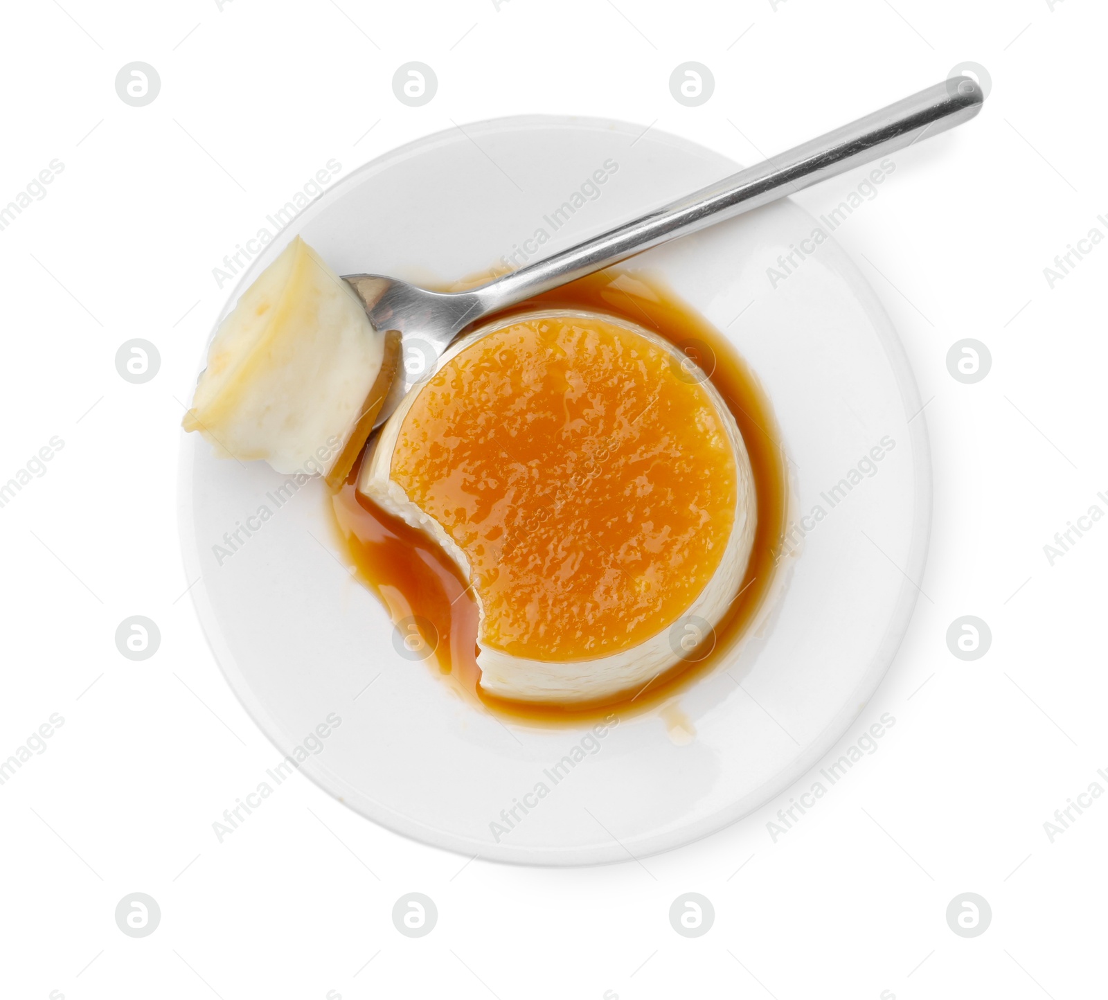 Photo of Tasty pudding with caramel sauce and spoon isolated on white, top view