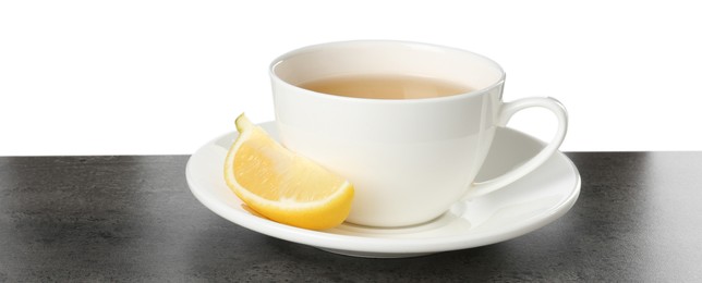 Photo of Refreshing green tea in cup and slice of lemon on grey textured table against white background. Space for text