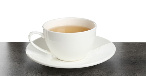 Photo of Refreshing green tea in cup on grey textured table against white background