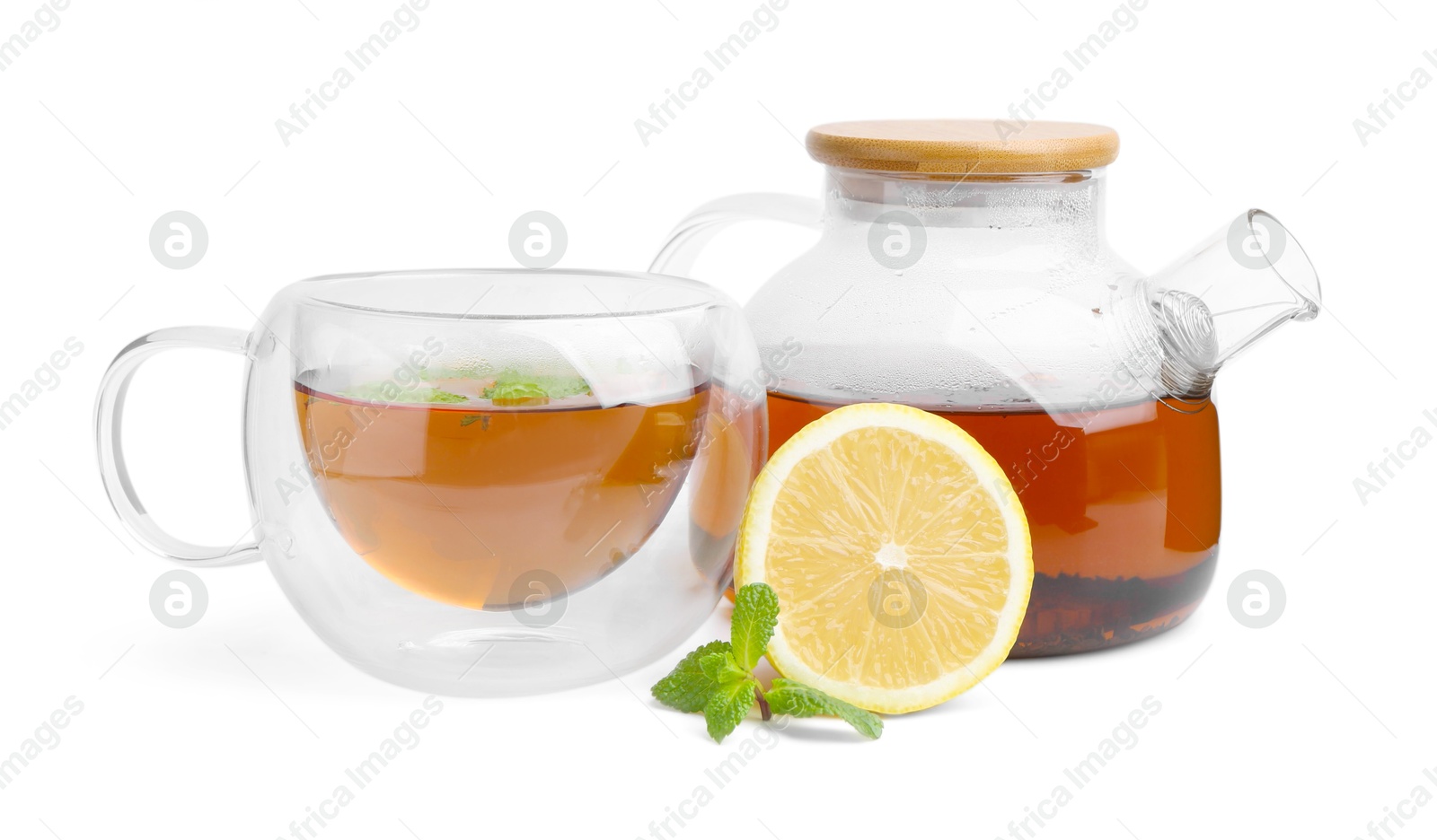 Photo of Tasty mint tea, lemon and fresh leaves isolated on white