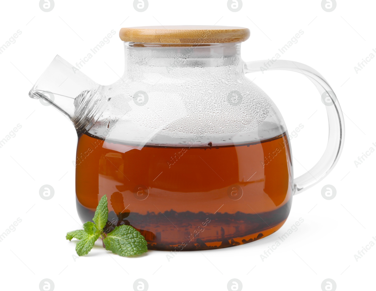 Photo of Tasty mint tea in teapot and fresh leaves isolated on white