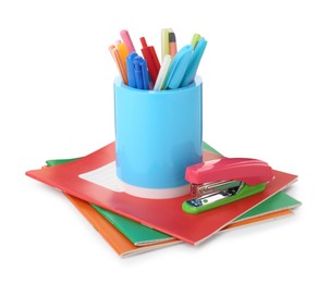 Photo of Doing homework. Copybooks and other different stationery on white background