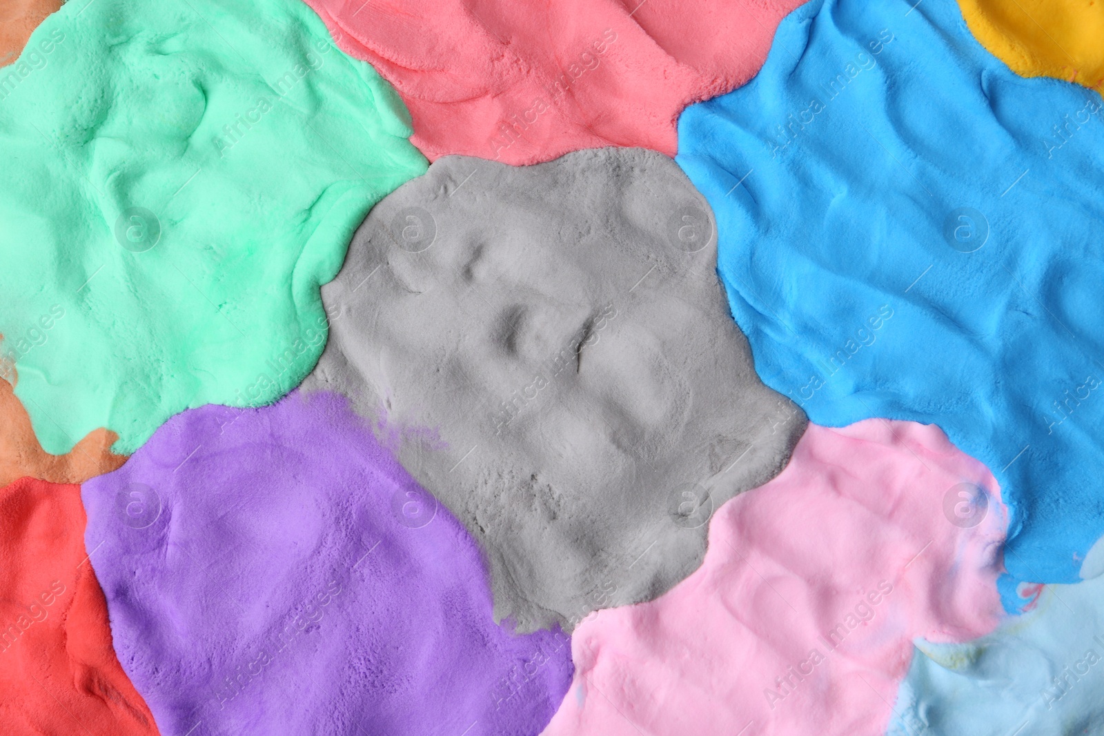 Photo of Different colorful play dough as background, top view