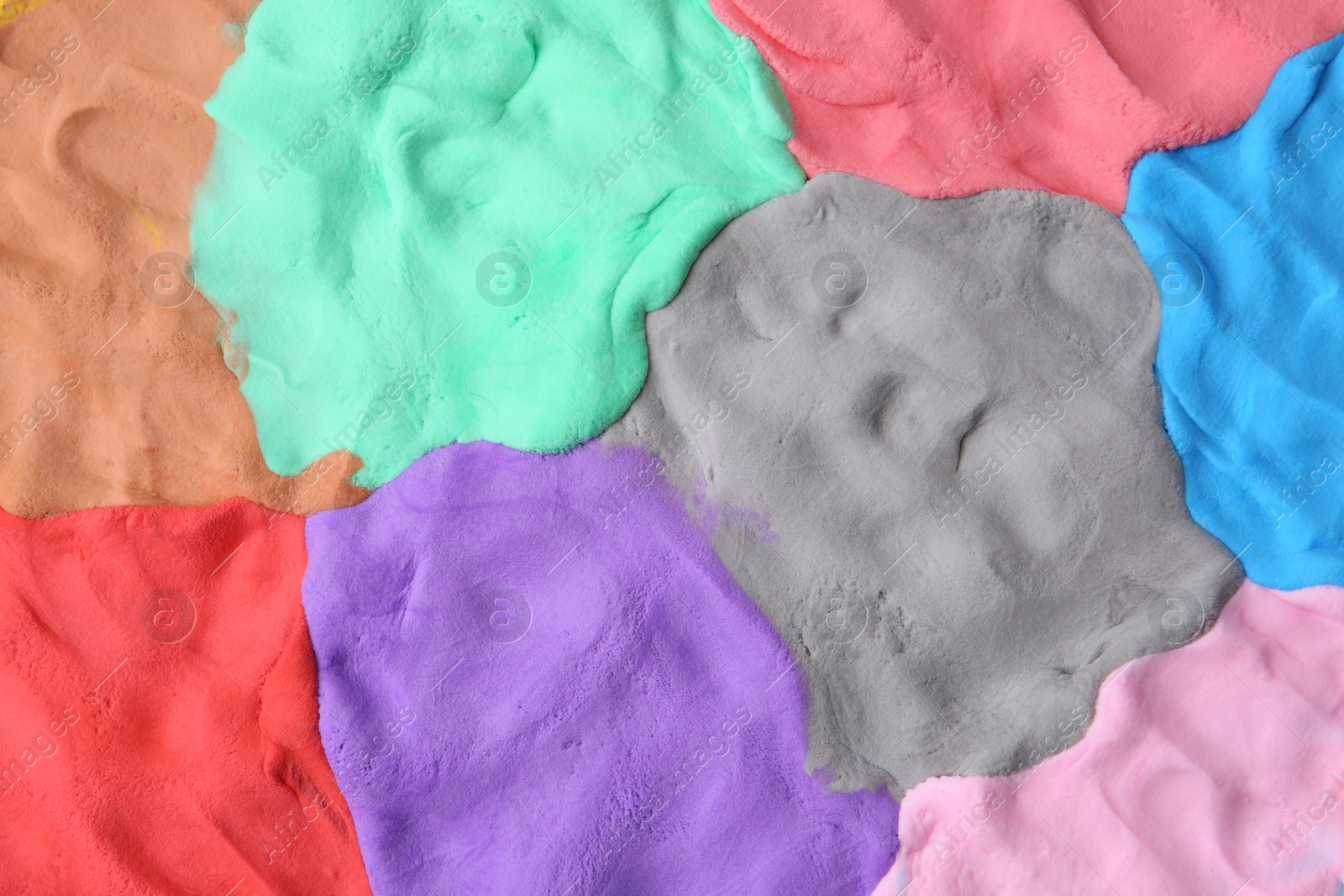 Photo of Different colorful play dough as background, top view