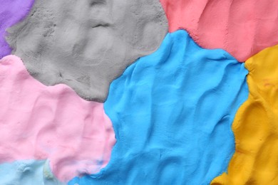 Photo of Different colorful play dough as background, top view