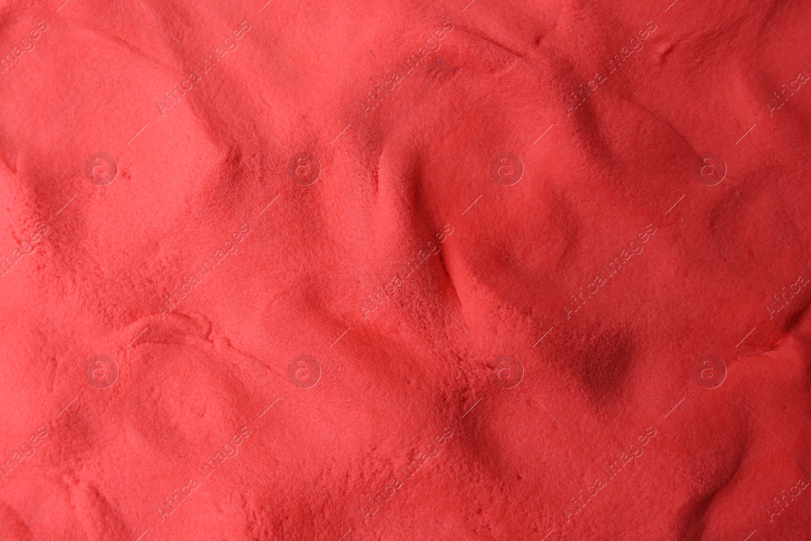 Photo of Red play dough as background, top view