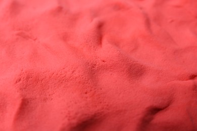 Photo of Bright red play dough as background, closeup