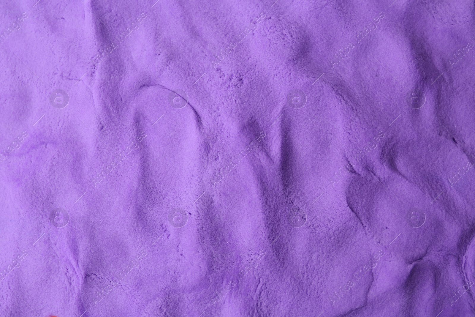 Photo of Purple play dough as background, top view