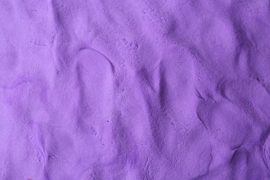 Photo of Purple play dough as background, top view