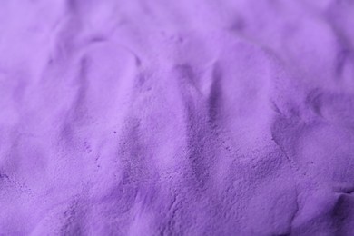 Photo of Bright purple play dough as background, closeup