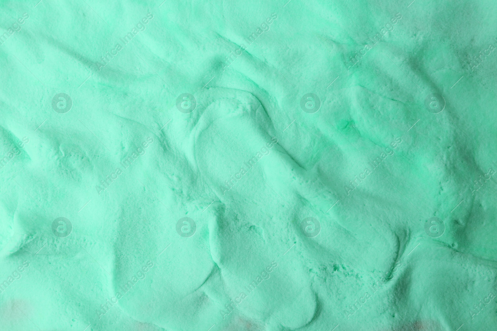 Photo of Turquoise play dough as background, top view