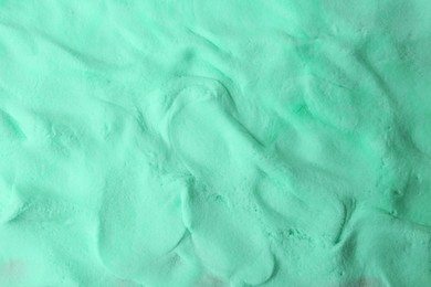 Photo of Turquoise play dough as background, top view