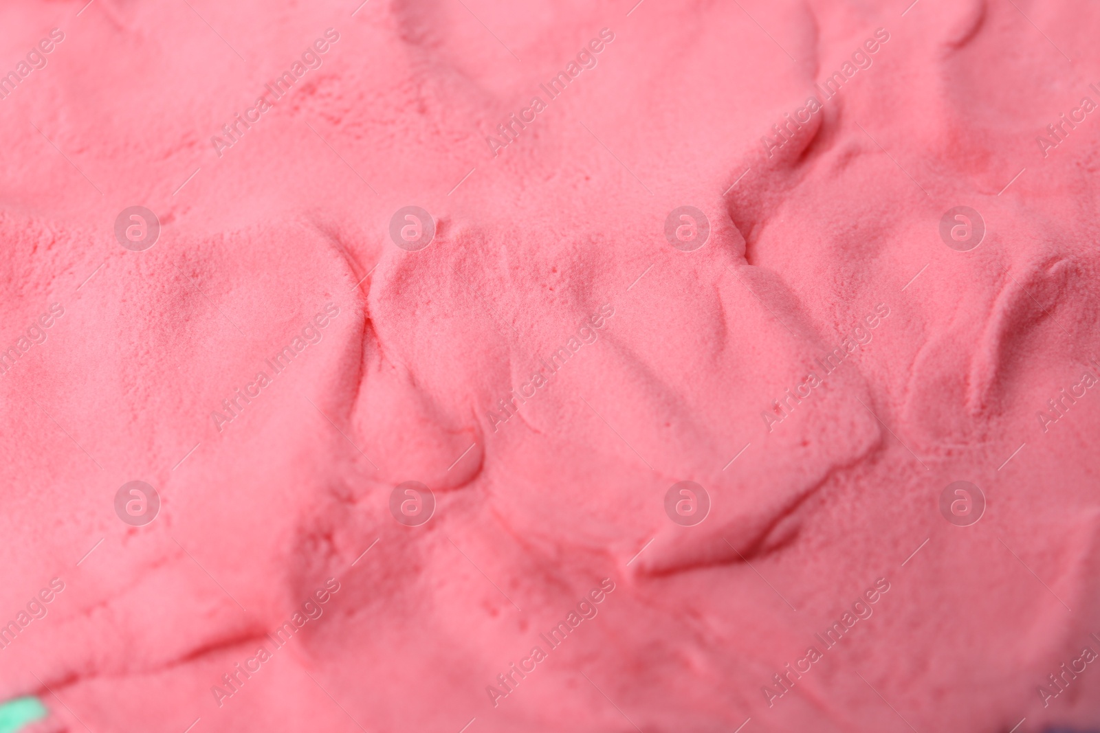 Photo of Bright pink play dough as background, closeup