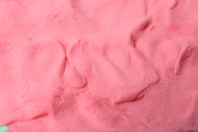 Photo of Bright pink play dough as background, closeup