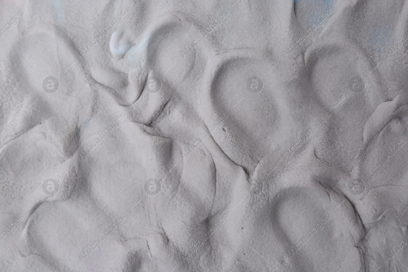 Photo of Grey play dough as background, top view