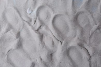 Photo of Grey play dough as background, top view