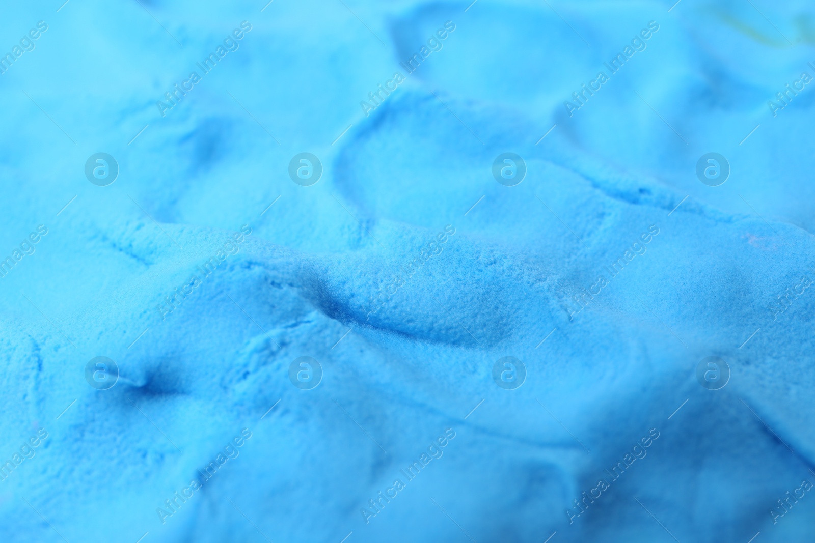 Photo of Light blue play dough as background, closeup