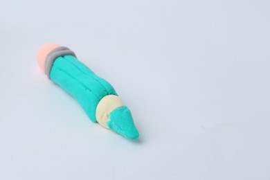 Photo of Pencil made from play dough on light grey background, closeup. Space for text