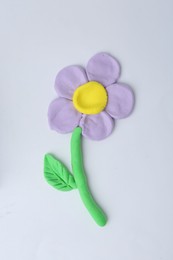 Photo of Flower made from play dough on light grey background, top view