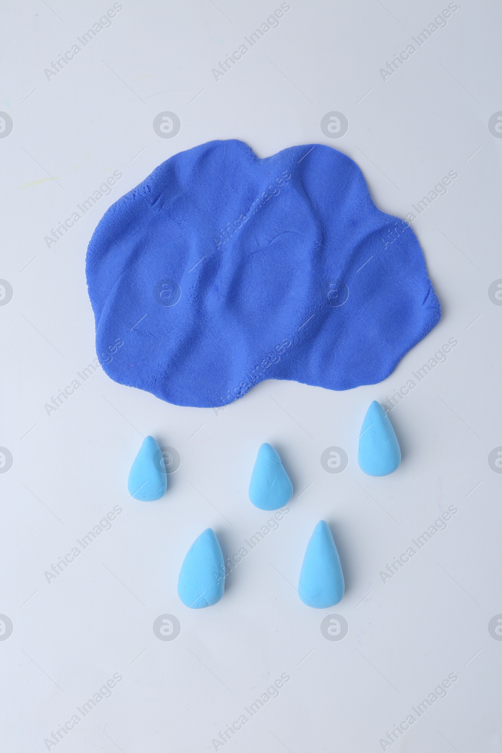 Photo of Cloud with rain drops made from play dough on light grey background, top view