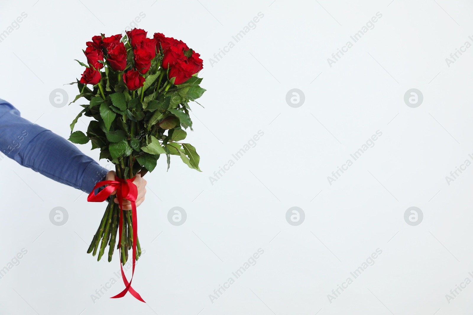 Photo of Happy Valentine's Day. Man with bouquet of roses on white background, closeup. Space for text