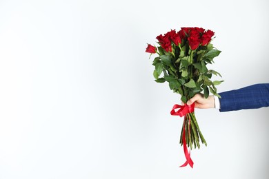 Photo of Happy Valentine's Day. Man with bouquet of roses on white background, closeup. Space for text