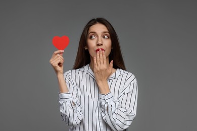 Photo of Happy Valentine's Day. Beautiful woman with paper heart on grey background