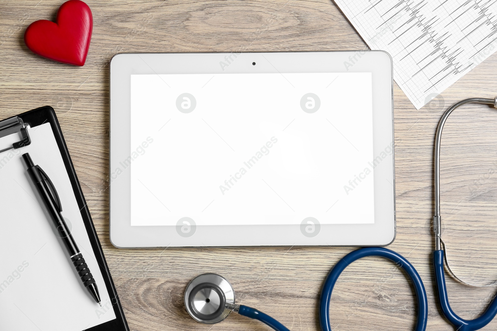 Photo of Cardiology. Flat lay composition with stethoscope and tablet on wooden table