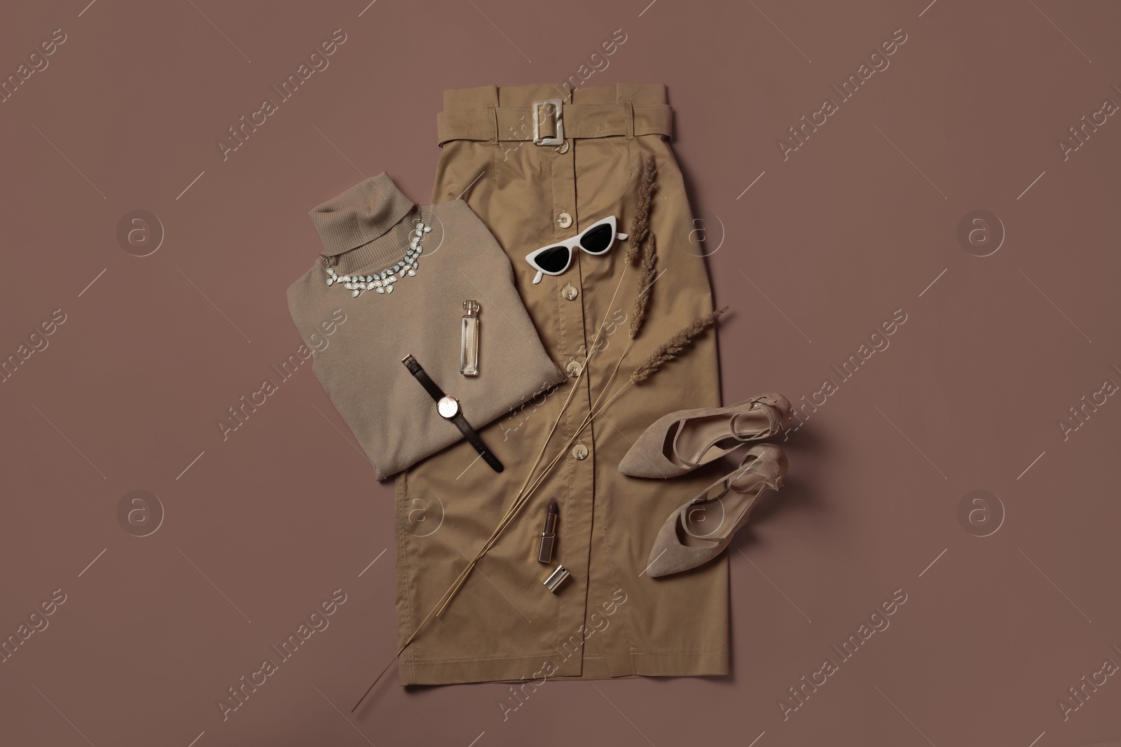 Image of Stylish shoes, clothes and accessories in mocha mousse on brown background, flat lay. Trendy color of 2025 year