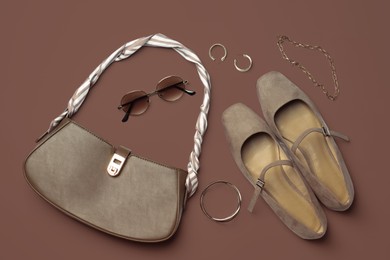 Image of Beautiful bag, shoes and stylish accessories on mocha mousse shade background, flat lay. Trendy color of 2025 year