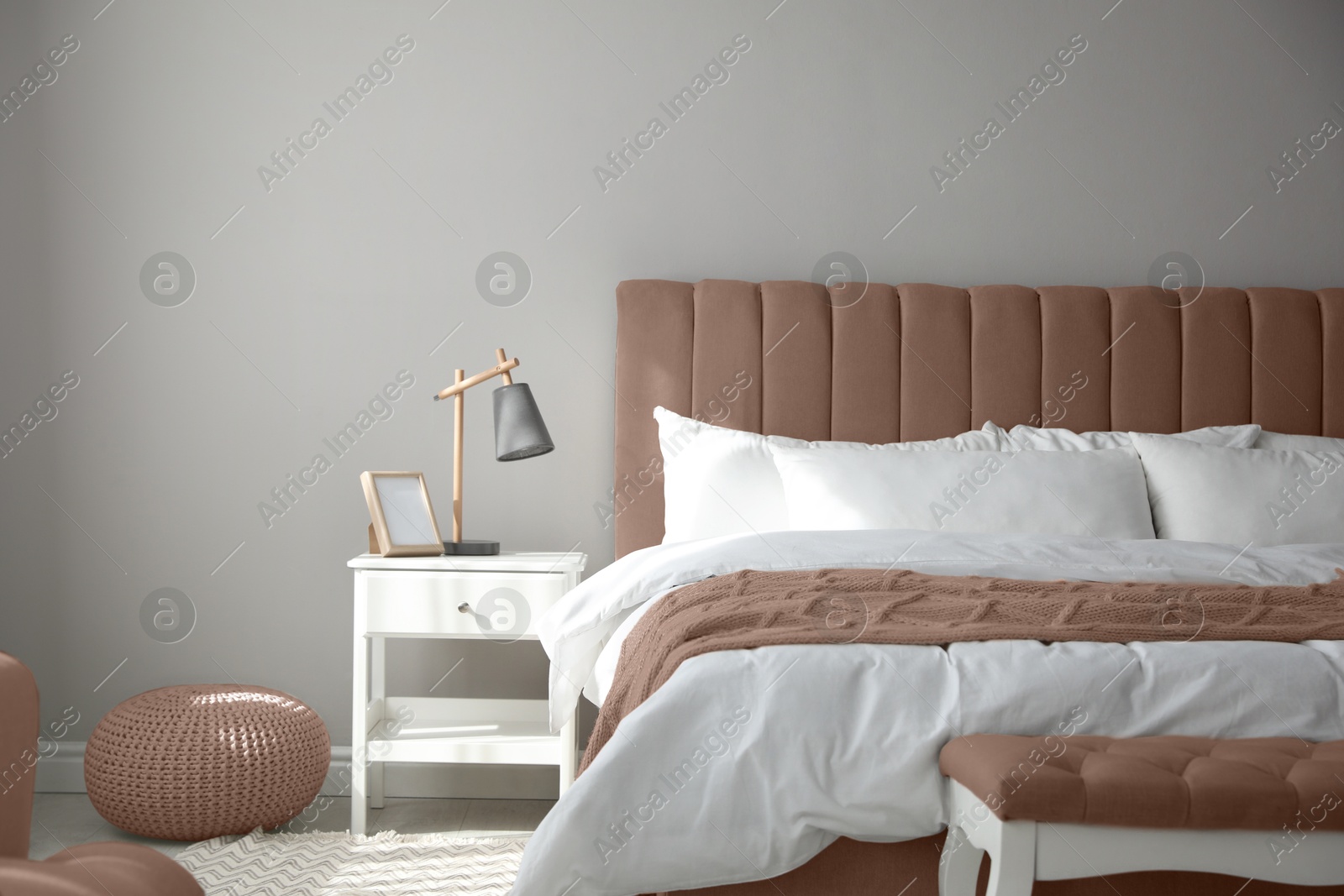 Image of Bedroom with furniture in mocha mousse shade. Stylish interior with trendy color of 2025 year