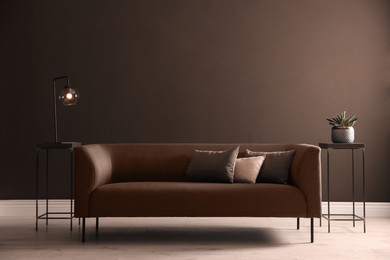 Image of Stylish room interior in mocha mousse shade. Sofa and wall in trendy color of 2025 year