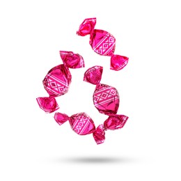 Image of Candies in bright wrappers falling on white background